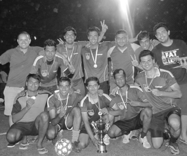 The football team posing with the trophy